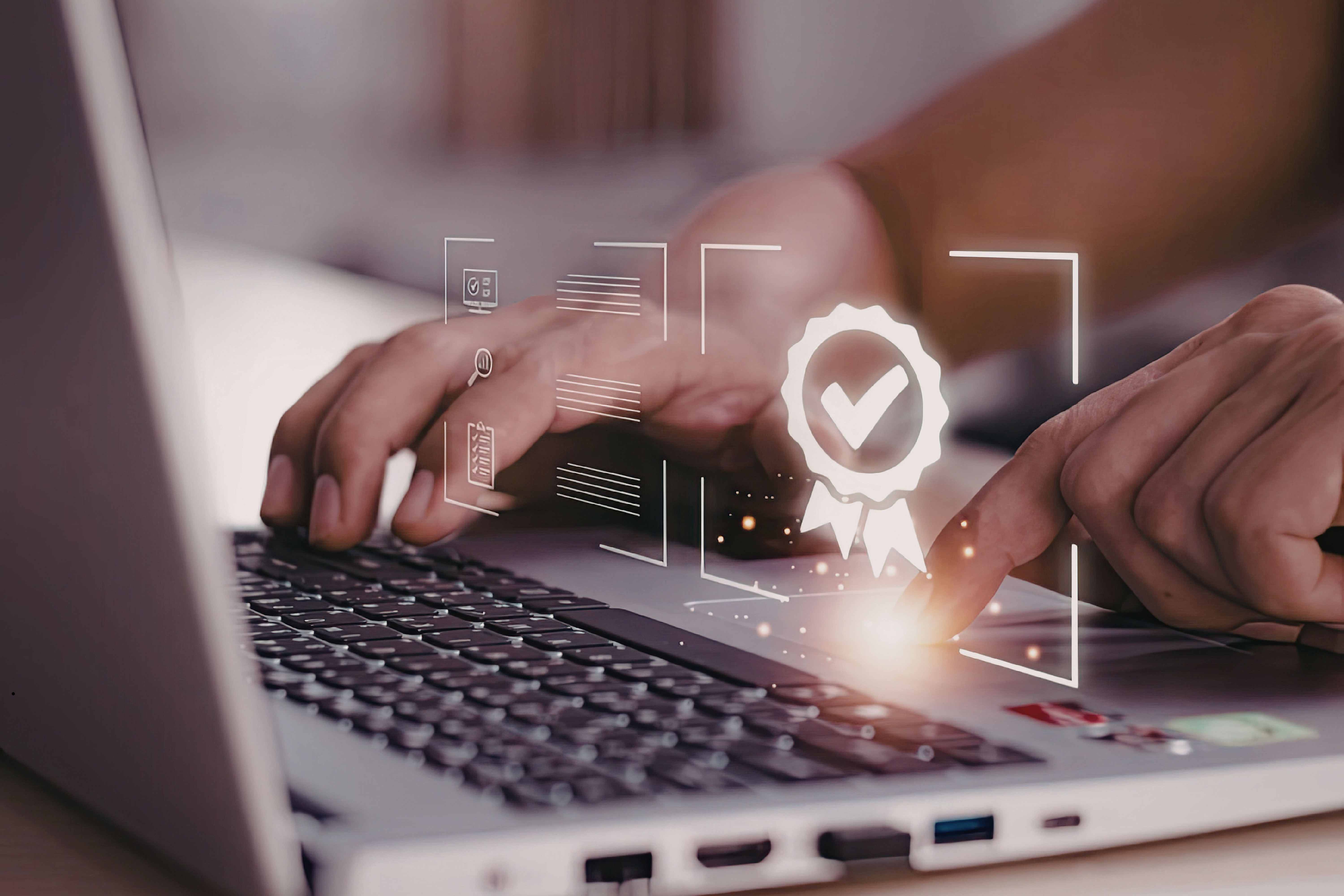 Klawiatura laptopa, nad którą wyświetlają się interaktywne grafiki.1